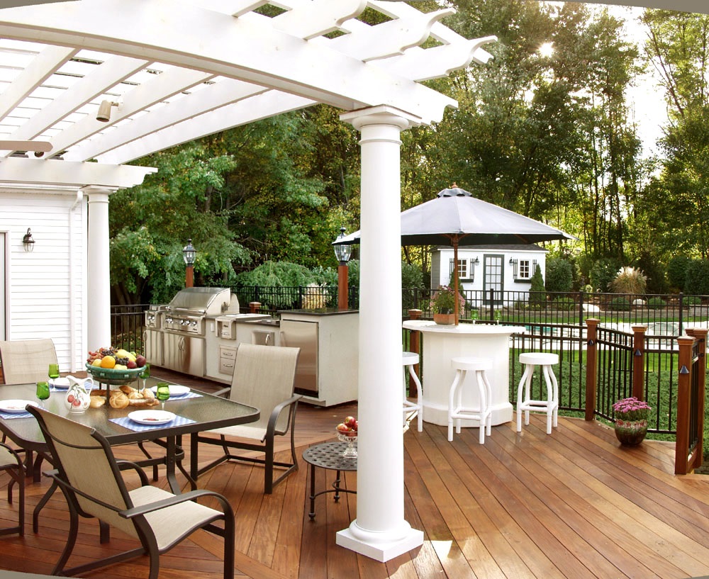 beautiful deck with an outdoor kitchen and living space